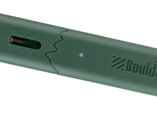 Close-up of a green electronic device with a charging port and LED indicator.